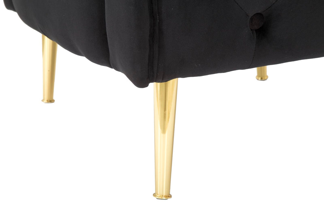 Sillón de terciopelo negro con patas de metal dorado