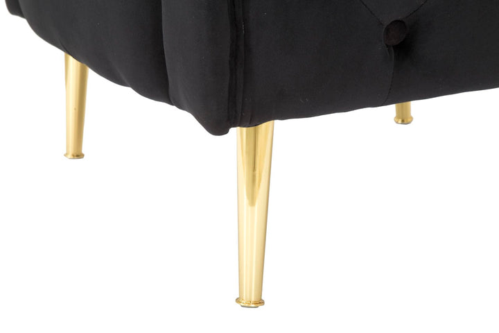 Sillón de terciopelo negro con patas de metal dorado