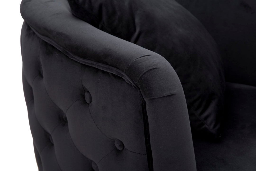 Sillón de terciopelo negro con patas de metal dorado