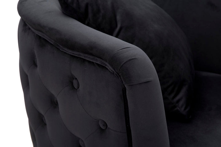 Sillón de terciopelo negro con patas de metal dorado