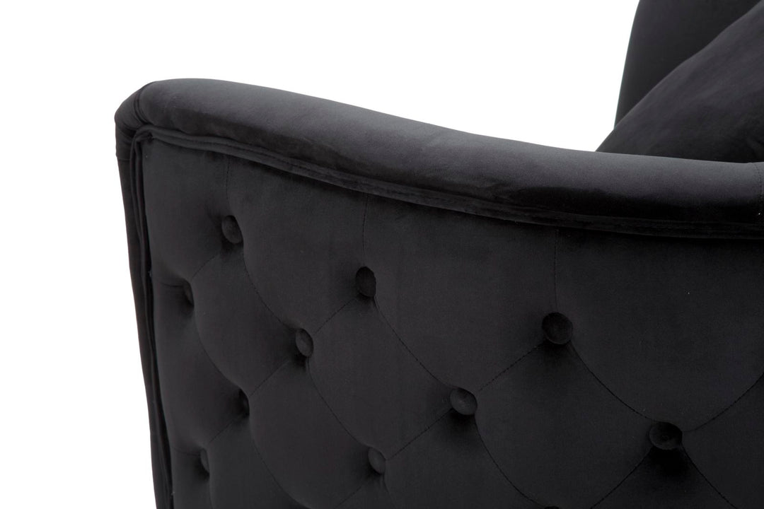 Sillón de terciopelo negro con patas de metal dorado