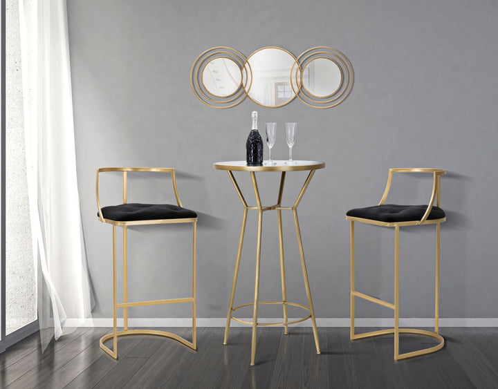 Taburete de terciopelo negro con patas de metal dorado