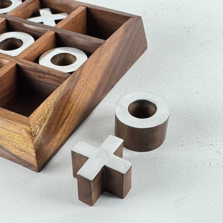 Tablero de tres en raya de madera con piezas de hierro